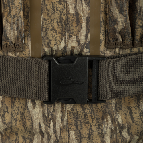 A close-up of a black buckle on a camouflage vest, part of the Insulated Guardian Elite Vanguard Breathable Waders - Habitat.