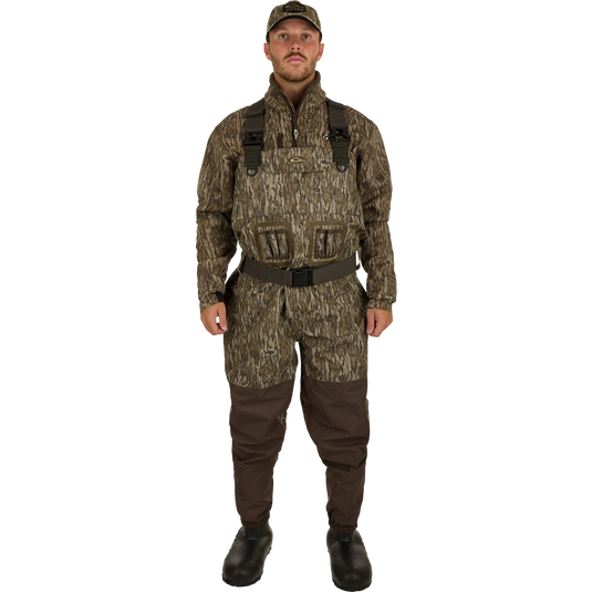 A man in camouflage uniform wearing Insulated Guardian Elite Vanguard Breathable Waders - Habitat, standing in military clothing.