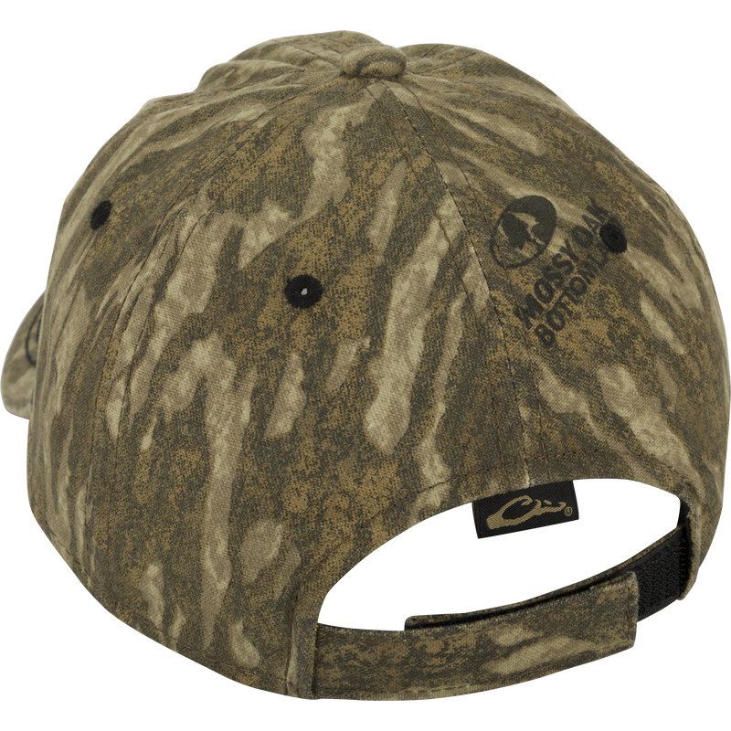 Camo Cotton Twill Hex Patch Cap - A close-up of a hat with a fabric label. Unstructured front panels and a hook and loop closure for a comfortable fit. Conquer the wild in this bold cap!