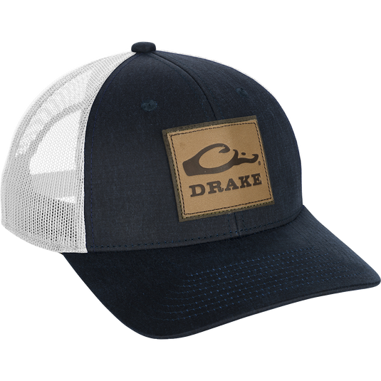 Leather Patch Mesh Back Cap with debossed Drake Logo, a black and white hat with a patch on it, in a traditional trucker shape.