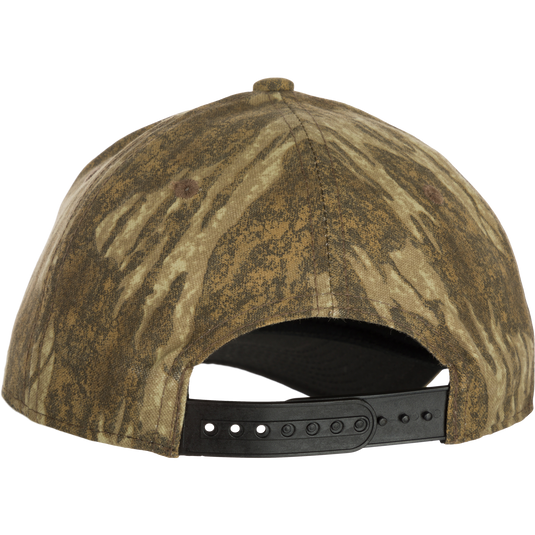 A close-up of the 6-Panel Badge Cap - Realtree, a must-have for any outdoorsman wardrobe. Constructed of six cotton blend panels with a rear snap closure for a secure fit. Final Sale.