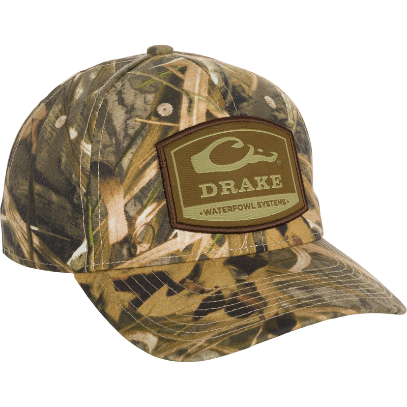 6-Panel Badge Cap: A close-up of a hat with a patch and logo. Classic design with a secure fit. Perfect for outdoor enthusiasts.