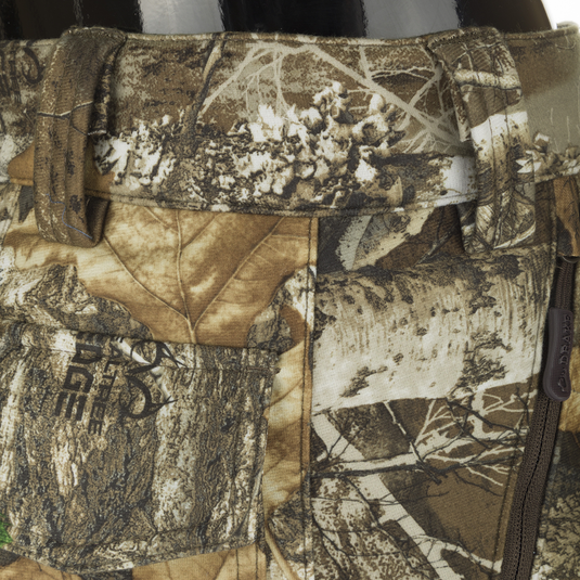 MST Microfleece Softshell Pant - Realtree: Close-up of camo pants with wind-resistant fabric, microfleece lining, and side zips for easy movement. Agion Active XL® scent control technology included.