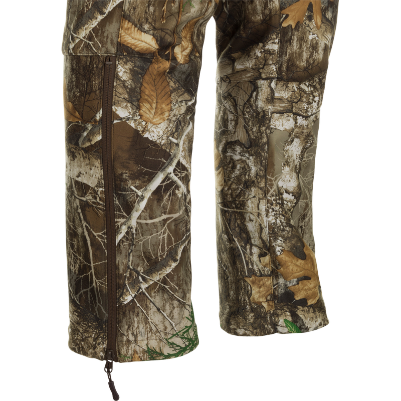 MST Microfleece Softshell Pants - Realtree. Camouflage pants with wind-resistant fabric, 4-way stretch, and moisture-repellent lining. Scent control technology, comfortable fit, and easy movement. Zippered pockets for storage. Ideal for hunting and outdoor activities.