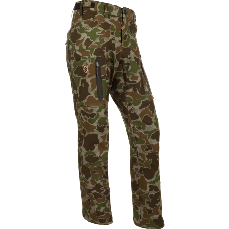 A pair of camouflage pants with 4-way stretch, zippered pockets, and hip vents. Ideal for cool to cold days afield. Pursuit Tech Stretch Pant with Agion Active XL® from Drake Waterfowl.