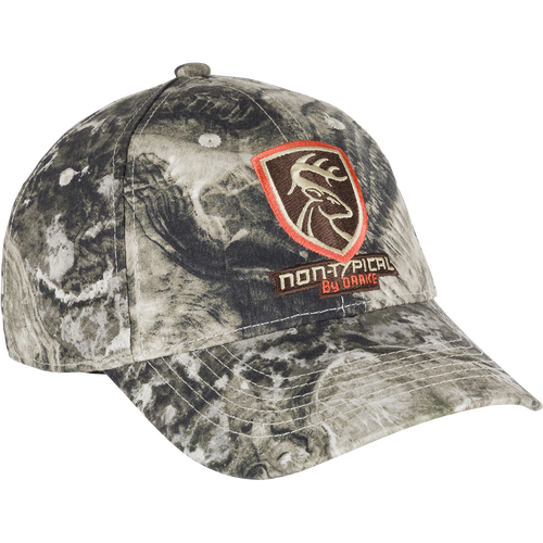 Non-Typical Logo Camo Cotton Cap - Mossy Oak Terra Coyote: A camouflage hat with a logo on it, made of 100% cotton twill fabric. Features a six-panel construction, mid-profile fit, and hook & loop closure. One size fits most.