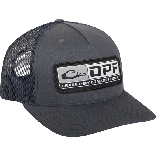 A black trucker cap with a patch and logo, featuring a 5-panel construction and adjustable snapback. Made of 60% cotton / 40% polyester shell with a nylon mesh back. Perfect for hunting, fishing, and casual wear.
