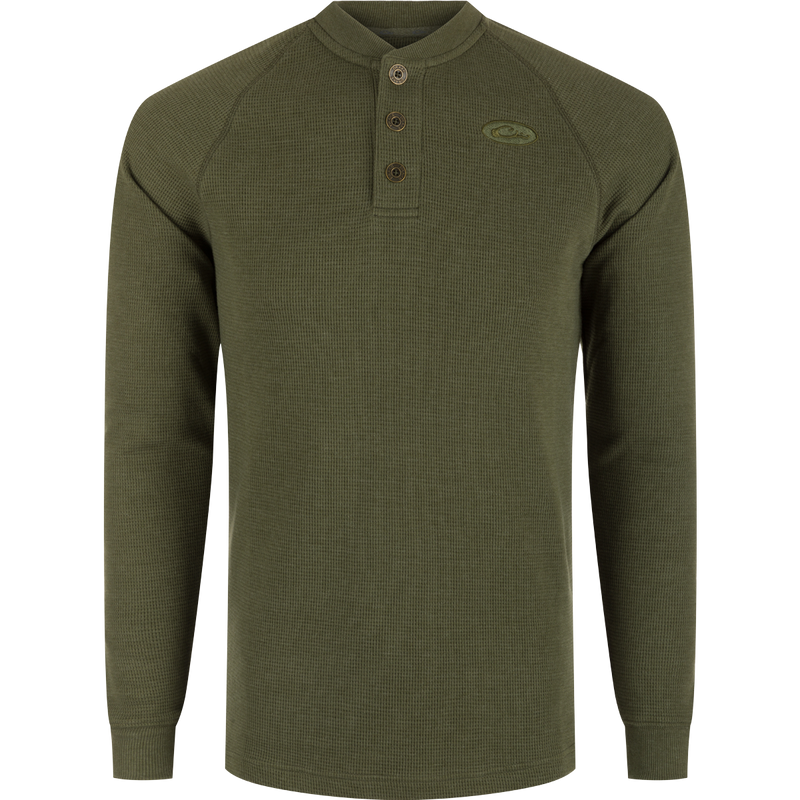 A durable Weston Lakes Waffle Henley in green, featuring raglan sleeves, metal logo buttons, ribbed collar, cuffs, and split tail hem. Ideal for hunting and outdoor activities.