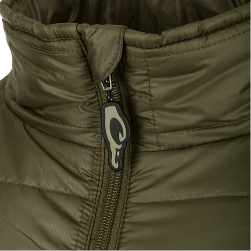 A close-up of our Synthetic Down Pac-Jacket, featuring a black and white logo, zipper, and fabric. Stay dry with the DWR Water Repellent Finish and enjoy the convenience of multiple pockets and adjustable waist. Adventure awaits!