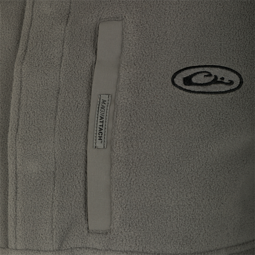 A close-up of the Camp Fleece Pullover 2.0 jacket's label and logo.
