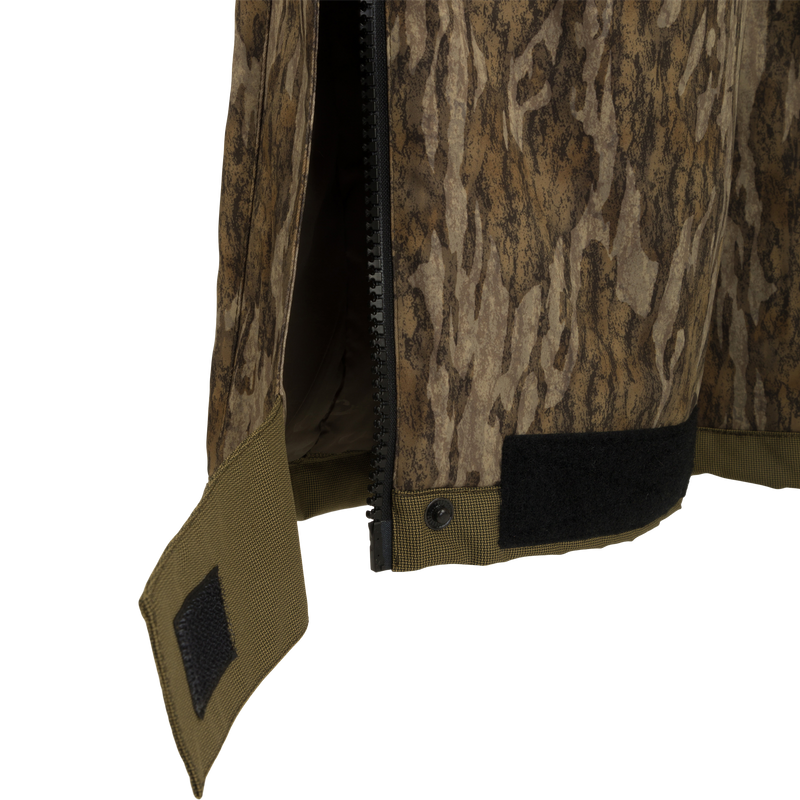 A close-up of the LST Reflex Insulated Bib, showcasing its durable and stretchy Reflex fabric. Waterproof and windproof, with polyester insulation for warmth. Knee-length zippers for easy on/off over boots. Reinforced knees and seat for toughness.
