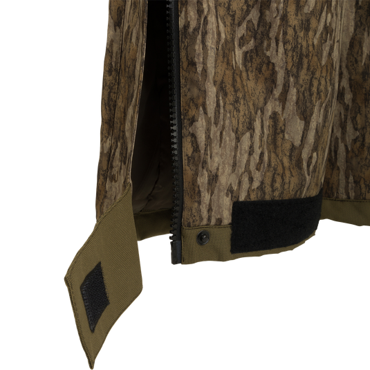 A close-up of the LST Reflex Insulated Bib, showcasing its durable and stretchy Reflex fabric. Waterproof and windproof, with polyester insulation for warmth. Knee-length zippers for easy on/off over boots. Reinforced knees and seat for toughness.
