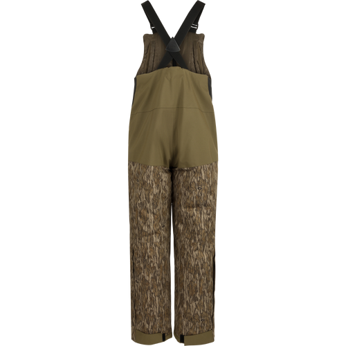 LST Reflex Insulated Bib: Brown overalls with tree pattern, knee-length zippers, reinforced knees and seat, fleece-lined hand warmer pockets.