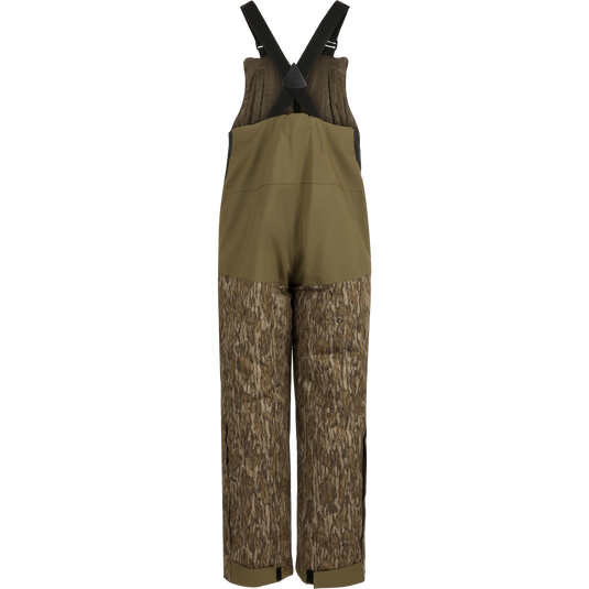 LST Reflex Insulated Bib: Brown overalls with tree pattern, knee-length zippers, reinforced knees and seat, fleece-lined hand warmer pockets.