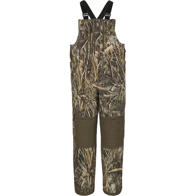 A youth-sized camouflage insulated bib with adjustable suspenders, knee-length zippers, and reinforced knees and seat.