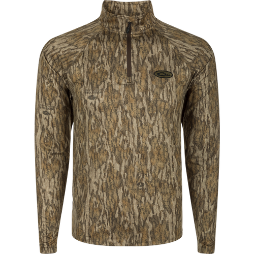 A long sleeved shirt with a tree pattern, the EST Microlite 1/4 Zip Pullover, optimized for performance with 4-way stretch, thumb loops, and UPF 50+ treatment.