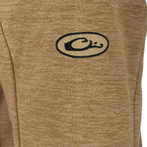 A close-up of the logo on the Heathered Windproof Full Zip jacket by Drake Waterfowl.