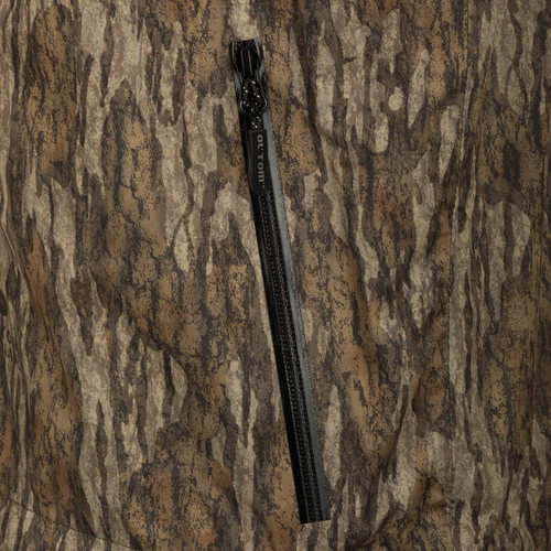 Ultralight Packable Rain Jacket with a pencil stuck in camouflage fabric, a close-up of a black belt, and a zipper on a tree.