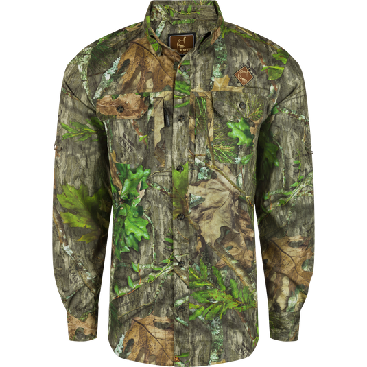 Men's Camo Wingshooter Trey Shirt L/S with hidden pockets, UPF30, and moisture-wicking fabric for hunting and outdoor activities by Drake Waterfowl.