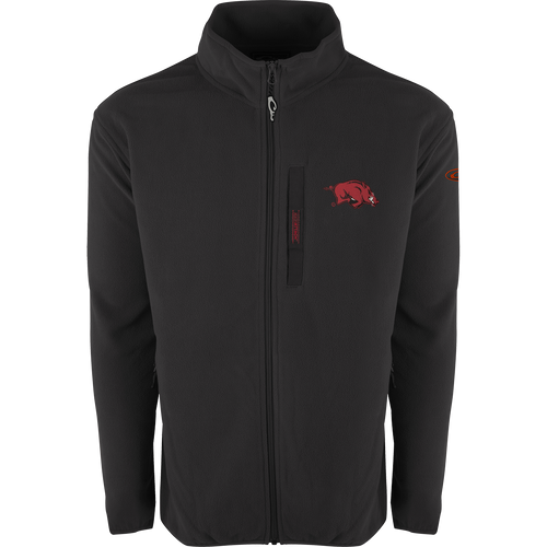 A black jacket with a red logo, featuring Arkansas Full Zip Camp Fleece. Windproof, water-resistant, and ultra-warm fleece material. Stand-up collar, Magnattach™ left chest pocket, and lower handwarmer pockets.