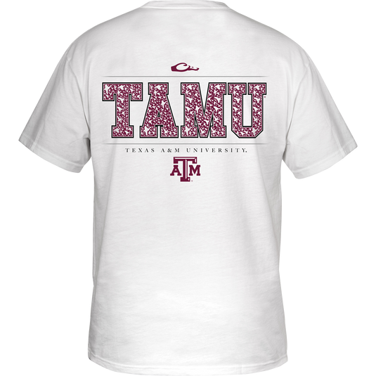 A white Texas A&M Block Letter Logo T-Shirt with ducks flying through the letters. Back artwork features ducks flying through TAMU. Front left chest has the Drake logo with Texas A&M Logo above. Tagless neck label for non-irritating comfort.
