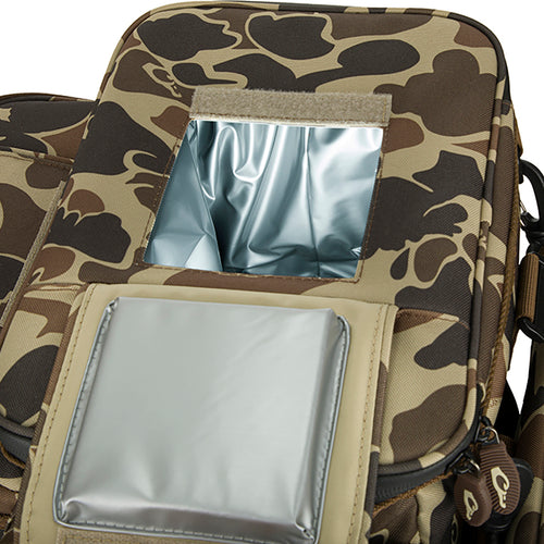 A camouflage bag with a window, perfect for carrying essentials and hydration into the dove field. Features a 12-Can/Bottle cooler compartment, quick-access flap for shells, and a removable mesh game bag. Drake's Wingshooter's Shell Boss.