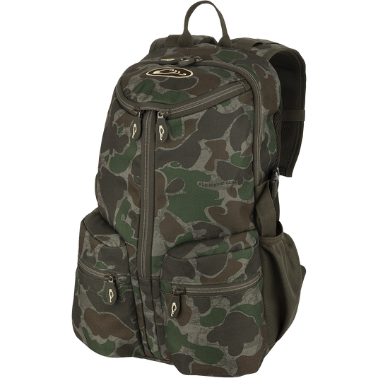 A compact and functional Vertical Zip Daypack, perfect for hunting or everyday use. Features include padded shoulder straps, large interior storage, external carry straps, and hydration bladder compartment. Made with 100% Polyester Rugged HD2™ Material and Drake’s Fowl-Proof™ YKK Zippers. Dimensions: 18.5"h x 11.5"w x 10.5"d.
