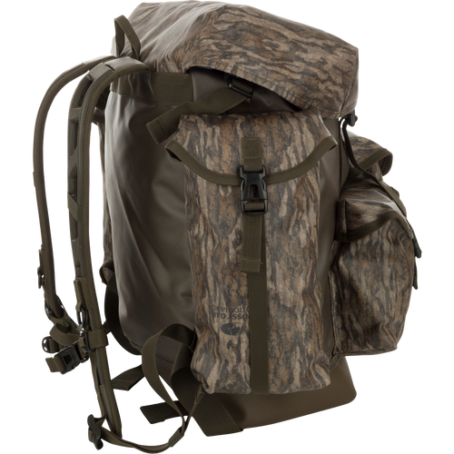 A rugged Swamp Pack with a camouflage pattern, perfect for your next hunt. PVC-coated polyester upper, nylon/TPU bottom, and EVA molded straps provide superior strength and weatherproof protection. Large roll-top main compartment keeps gear dry, while 5 outer compartments organize shells and necessities.