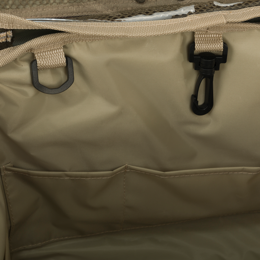 A close-up of the Large Blind Bag by Drake Waterfowl, featuring 18 pockets for organizing gear. Waterproof construction with durable nylon/TPU bottom. Improved thermos/jacket sleeve and adjustable shoulder strap. Dimensions: 18"L x 11"H x 10"D. Weight: 3.6 lbs.