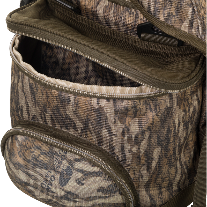 A close up of the Large Blind Bag by Drake Waterfowl, featuring 18 pockets for organizing gear. Waterproof construction with durable nylon/TPU bottom and vinyl liners. Improved thermos/jacket sleeve and adjustable shoulder strap. Dimensions: 18