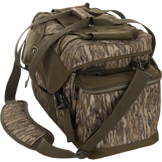 Large Blind Bag: A camouflage bag with straps, loaded with 18 pockets for organizing gear. Waterproof, durable, and abrasion-resistant. Adjustable shoulder strap. Dimensions: 18"L x 11"H x 10"D. Weight: 3.6 lbs. From Drake Waterfowl, a store specializing in high-quality hunting gear and clothing.