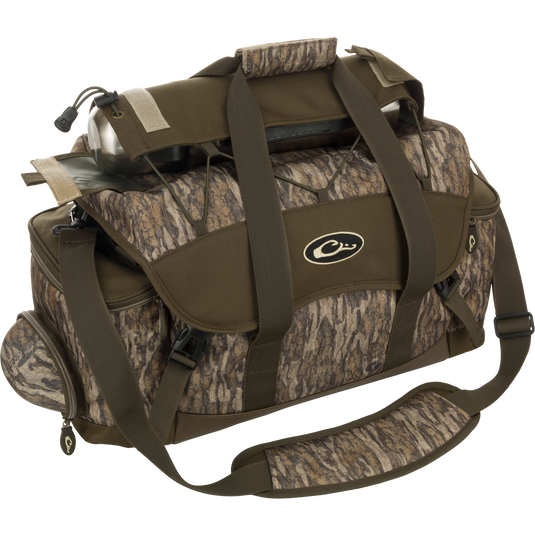A large camouflage duffel bag with water bottle, featuring 18 pockets for organizing gear. Waterproof, durable, and abrasion-resistant construction. Adjustable shoulder strap and various storage compartments. Dimensions: 18"L x 11"H x 10"D. Weight: 3.6 lbs.