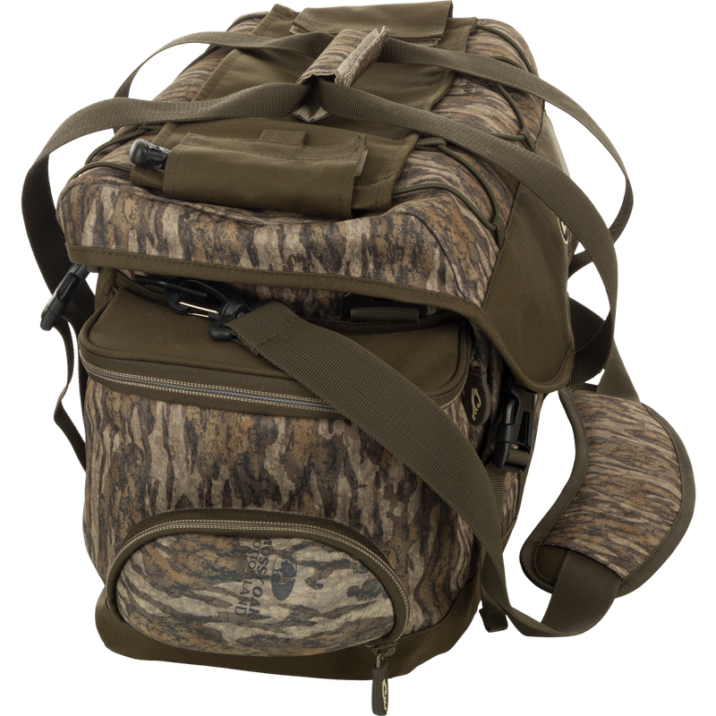 Extra Large Blind Bag - A camouflage bag with multiple pockets and adjustable strap for organizing hunting gear efficiently. Waterproof and durable design with a thermos/jacket sleeve and shell pockets. Perfect for waterfowl, turkey, and big game hunting.