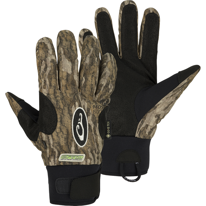 A pair of EST Refuge HS GORE-TEX Gloves with waterproof/breathable protection for waterfowl hunters. Features include a digitized goat skin leather palm and gusseted neoprene cuffs. Stay-Put™ liner system eliminates twisting and bunching. Adjustable gusset Velcro cuff closure and pull loop assist for easy on/off.