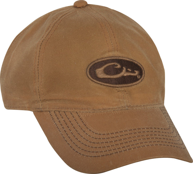 A mid-profile, six-panel Box Waxed Canvas Cap with a Drake Waterfowl logo patch on the front. Self fabric closure with brass slide adjustment on the back.