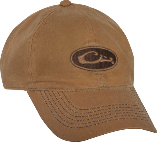 A mid-profile, six-panel Box Waxed Canvas Cap with a Drake Waterfowl logo patch on the front. Self fabric closure with brass slide adjustment on the back.