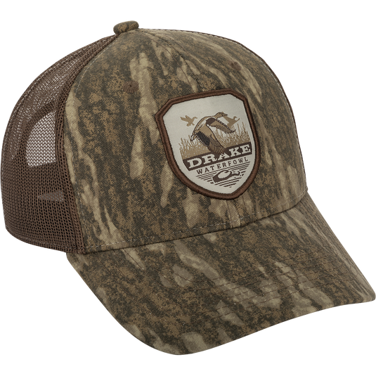 Vintage Badge Mesh Back Cap with Drake logo, a hat with a logo on it. Classic trucker style with a duck shield patch on a camouflage uniform.