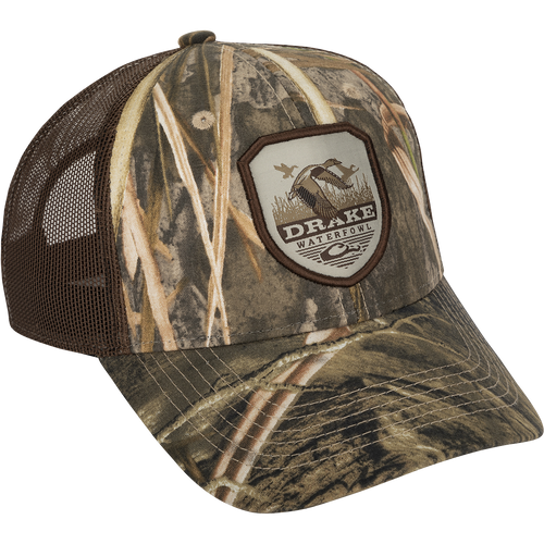 A vintage duck shield patch on a classic trucker mesh-back cap with the Drake logo, a go-to part of your outfit for any occasion.