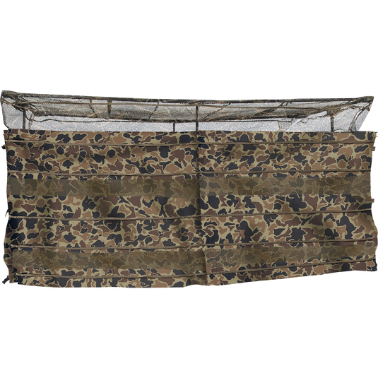 Ghillie Clubhouse 6-Man Blind with No-Shadow Dual Action Top, a spacious portable blind for hunting. Allows shooting out front or back, with see-through mesh top and brush straps for camouflage. Ideal for groups, with front and rear entry/exit gates. Can be used on dry ground or in water, and adjustable legs for various terrains. Easy setup and breakdown.