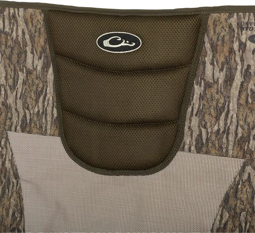 XL Low Profile Hunting Chair: Close-up of a bag with a black and white logo, net, fabric, and sign. Rugged, comfortable, and foldable design for low-profile hunting. Lightweight and easy to carry.