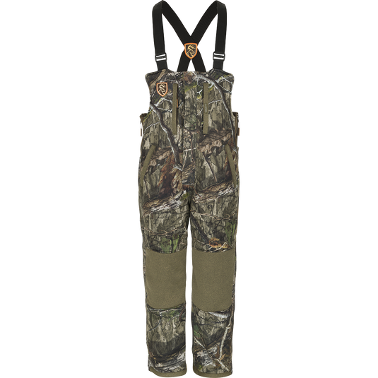 A Silencer Bib with Agion Active XL®, featuring camouflage overalls with straps and vertical pockets for hunting gear.