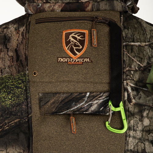 A close-up of the Stand Hunter's Silencer Jacket with Agion Active XL®. Features include scent control technology, multiple pockets, shoulder backpack straps, and a detachable fleece-lined hood. Perfect for late-season hunting.