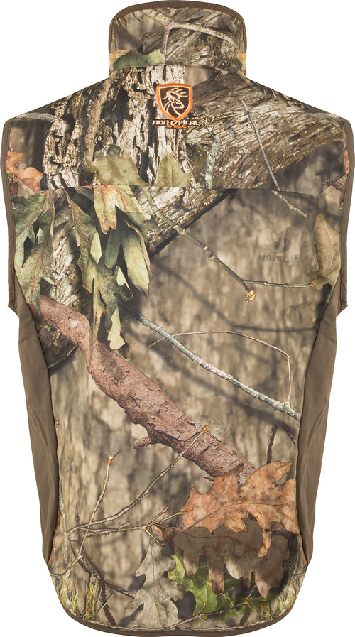 Camo Tech Vest with Agion Active XL: A camouflage vest with leaves and tree patterns. Ideal for bow hunters, providing arm movement and windproof protection. Multiple pockets for quick access to necessities. Versatile and durable for all-season use.