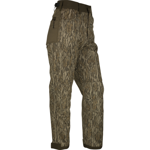 A pair of Standstill Windproof Pants with Agion Active XL®, perfect for late-season hunts. Made of durable polyester fabric with scent control technology. Features front slash pockets, cargo pockets, rear pockets, adjustable waist, and cuffs. Ideal for harsh cold and winds.