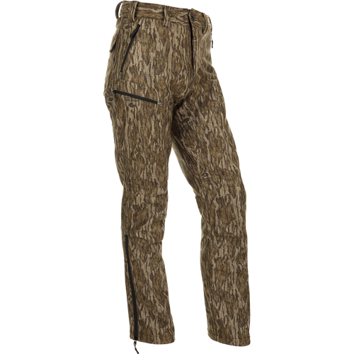 MST Microfleece Softshell Pants with camouflage pattern, wind-resistant fabric, and 4-way stretch. Features scent control technology, comfortable fit, gusseted crotch, articulated knees, and zippered pockets. Ideal for hunting and outdoor activities.