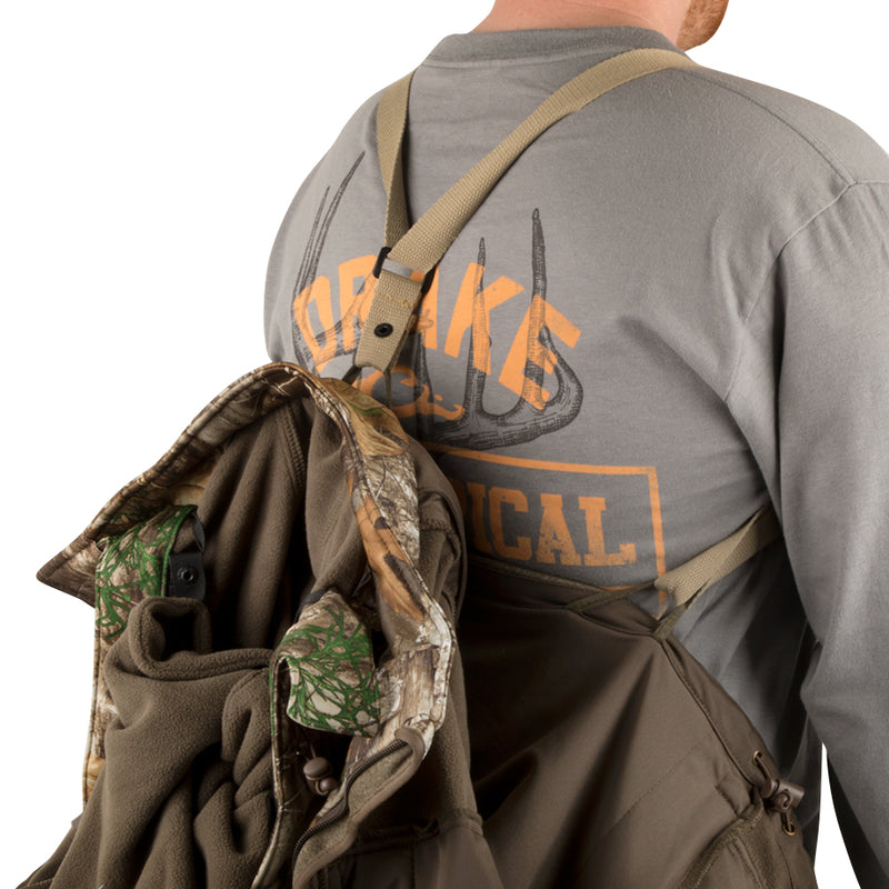 A man wearing the Stand Hunter's Silencer Jacket with Agion Active XL® and carrying a backpack.