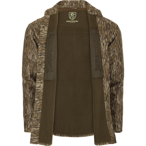 MST Microfleece Softshell Shirt: A camouflage jacket with a deer logo, featuring wind-resistant fabric, microfleece lining, scent control technology, 4-way stretch, and convenient pockets.