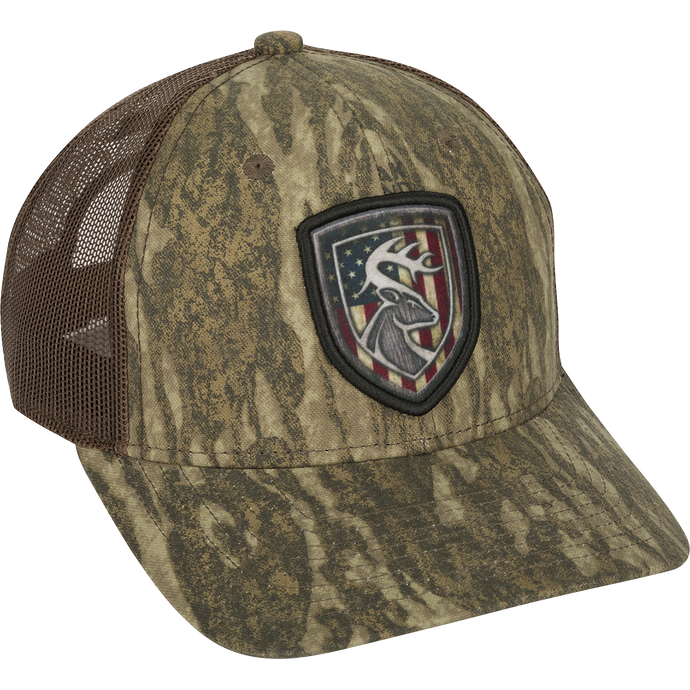 Americana Shield Patch Mesh-Back Cap with a deer flag patch on a hat. 100% cotton twill front panels with breathable mesh on the back. Rear snap closure.