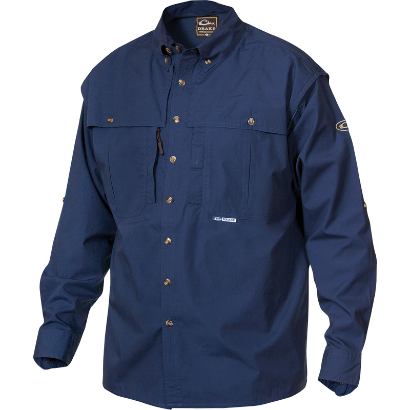 A blue long-sleeved shirt with a brown and white logo, front and back ventilation, oversized chest pockets, and a vertical zippered pocket. StayCool™ fabric keeps you cool and dry. Perfect for outdoor activities or casual office wear.
