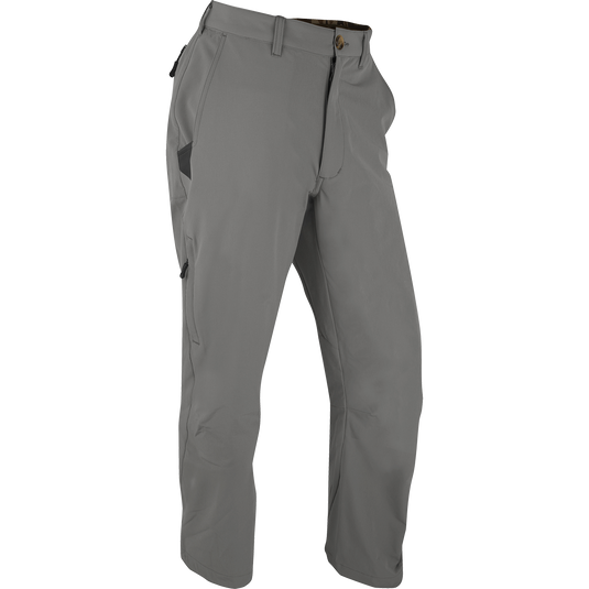 A pair of lightweight and durable Stretch Tech Pants with 4-way stretch and moisture-wicking qualities. Features gusseted crotch, articulated knee, YKK zippers, side stash pockets, and two cargo pockets. Perfect for outdoor activities.